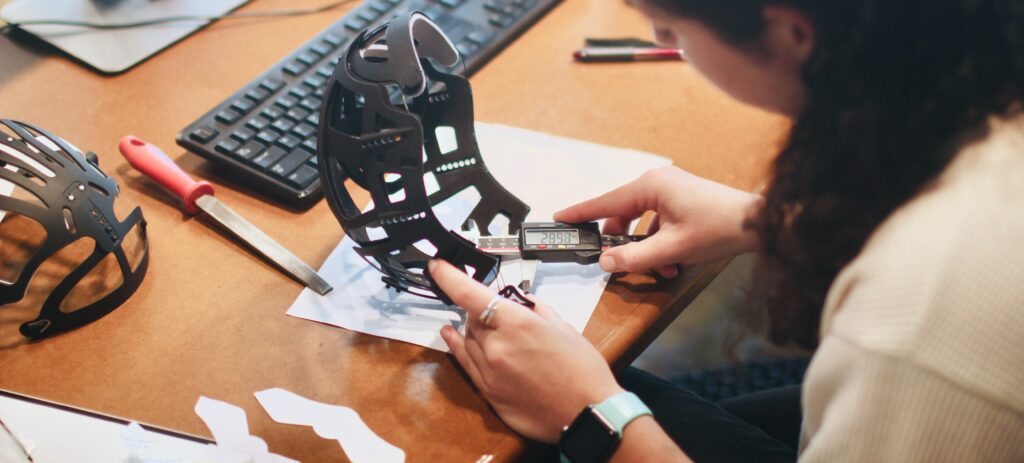 A woman checks the quality of a device.