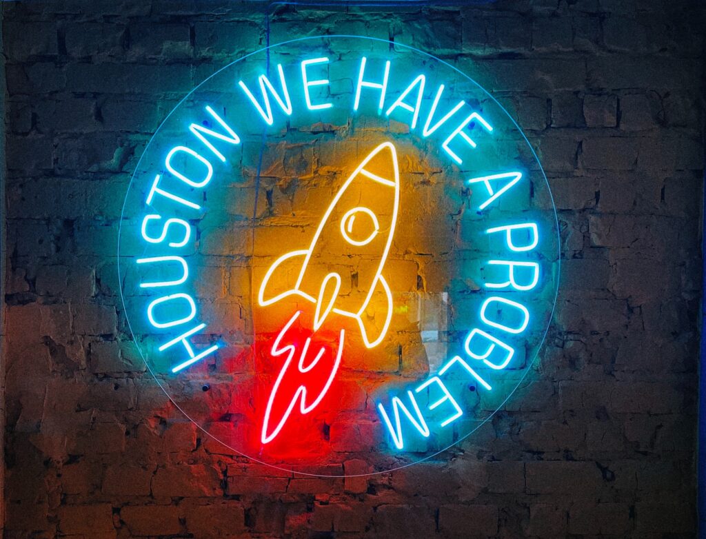 A neon sign reading "Houston We Have a Problem" meant to highlight the status of the bioeconomy.