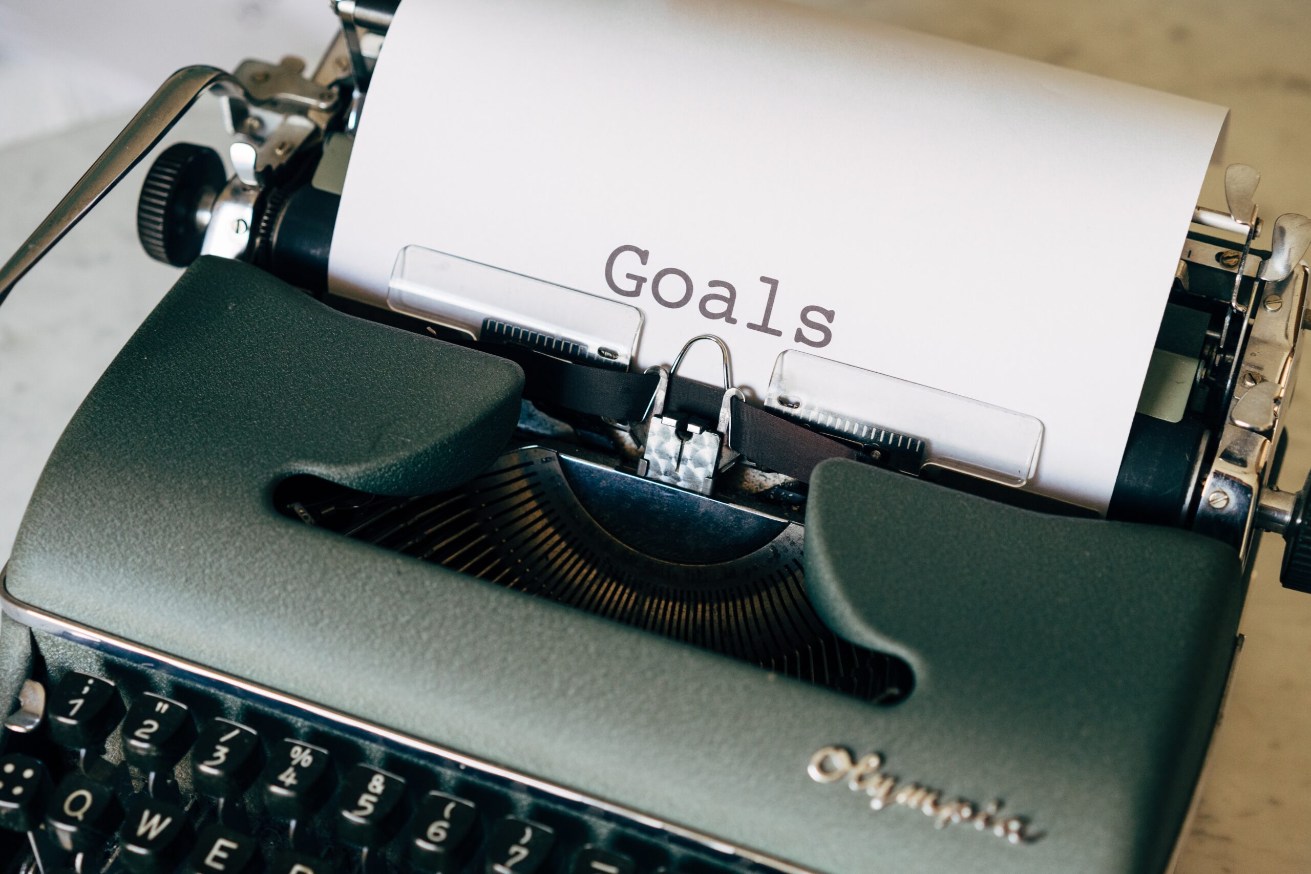 A picture of a typewriter with the text "Goals" typed out, meant to signify the importance of setting goals for the bioeconomy.