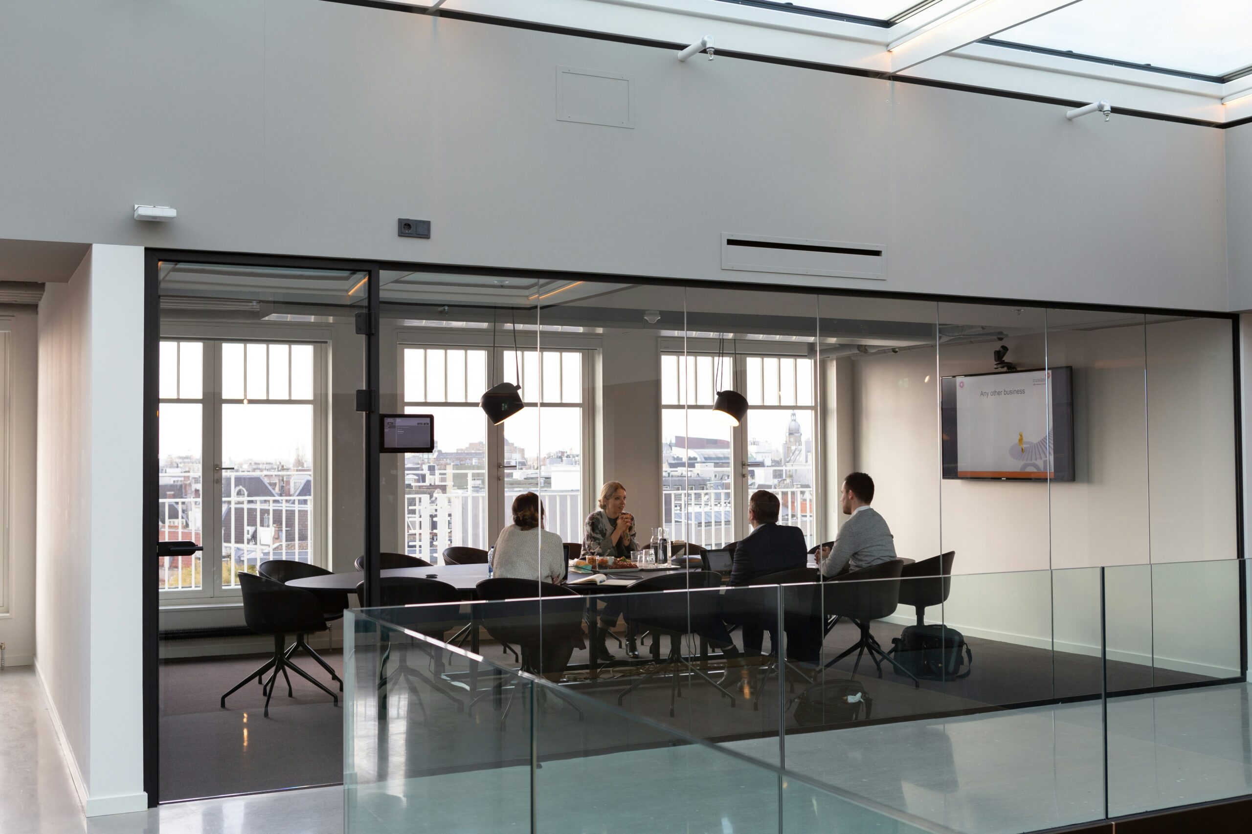 A group of employees meet in a conference room. 