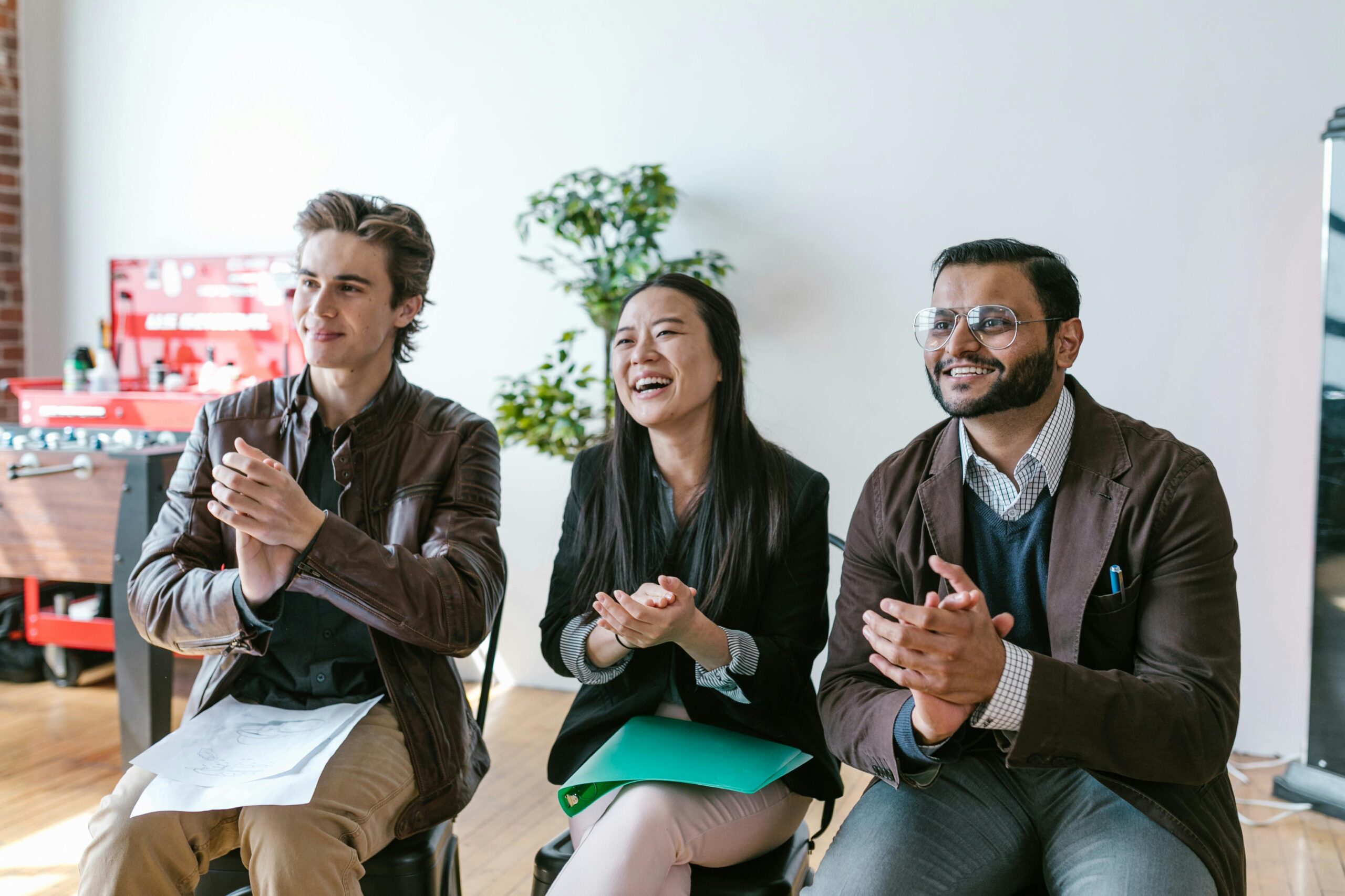A picture of three people applauding, meant to signify startup funding.
